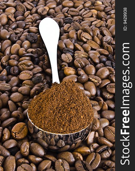 Spoon of coffee on a background grains.