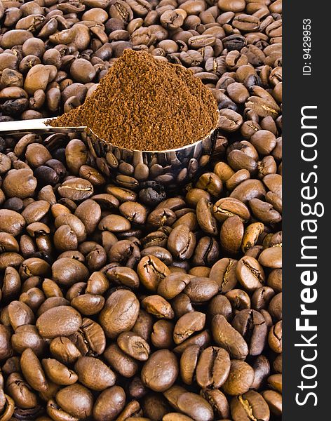 Spoon of coffee on a background grains.