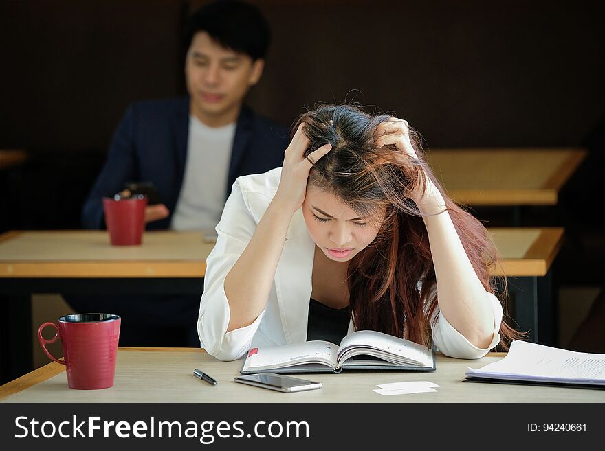 Businesswoman working have a headache work out working at a coffee shop