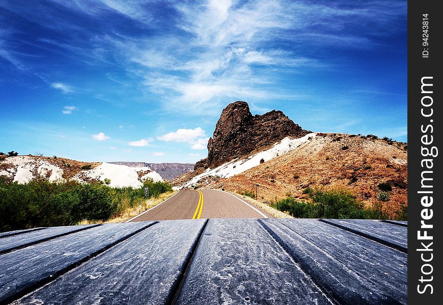 Scenic View of Mountain Road Against Blue Sky