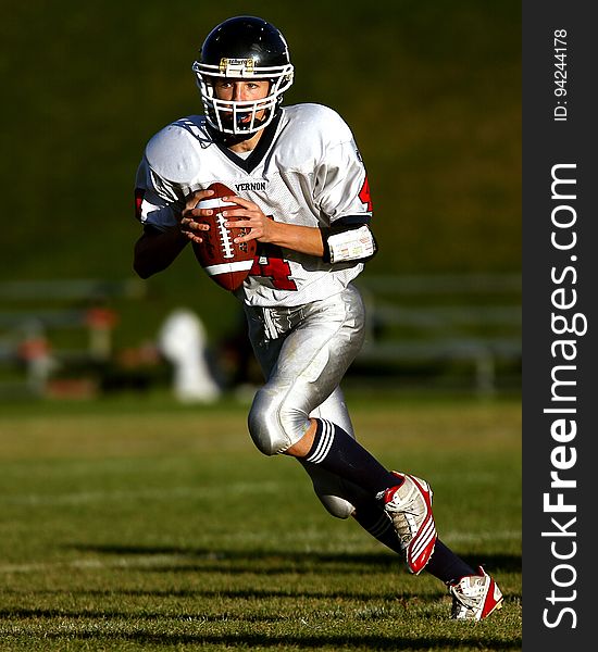 Man Holding Football While Running