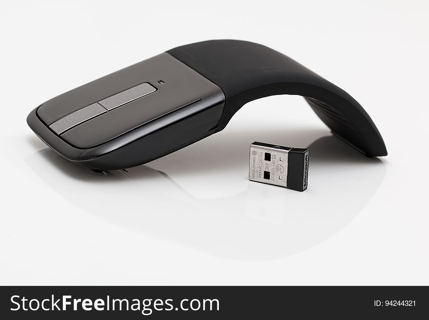 Black curved mouse with USB drive on white. Black curved mouse with USB drive on white.