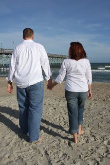 Couple Walking On The Beach Royalty Free Stock Photos