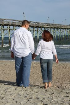 Couple Walking On The Beach Too Stock Photos Couple Walking On The Beach Too Stock Photos