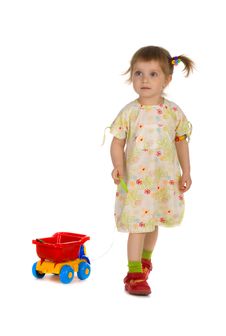 Little Girl Carries The Toy Car Royalty Free Stock Photography