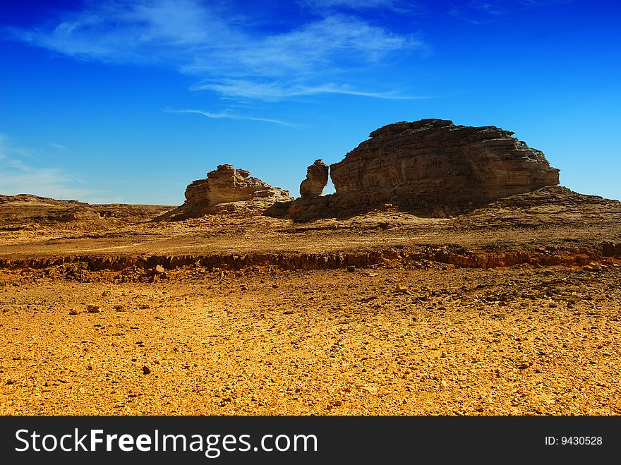 Big rock in the desert with a blue sky