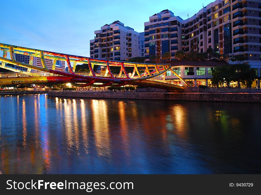 Silent night life with colorful bridge along Singapore river