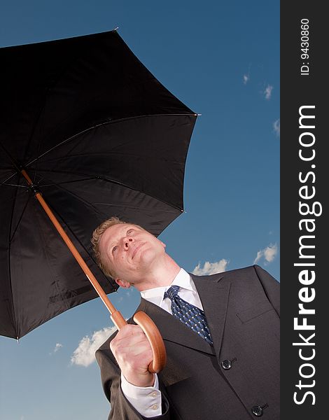 A man holds an umbrella on a sunny day. A man holds an umbrella on a sunny day