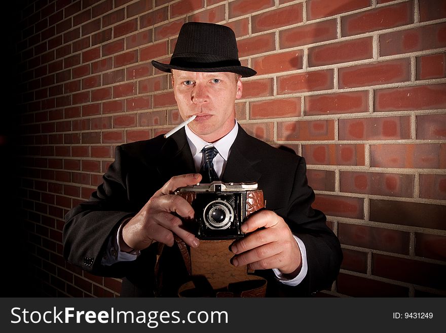 A man takes a photo with an old camera. A man takes a photo with an old camera