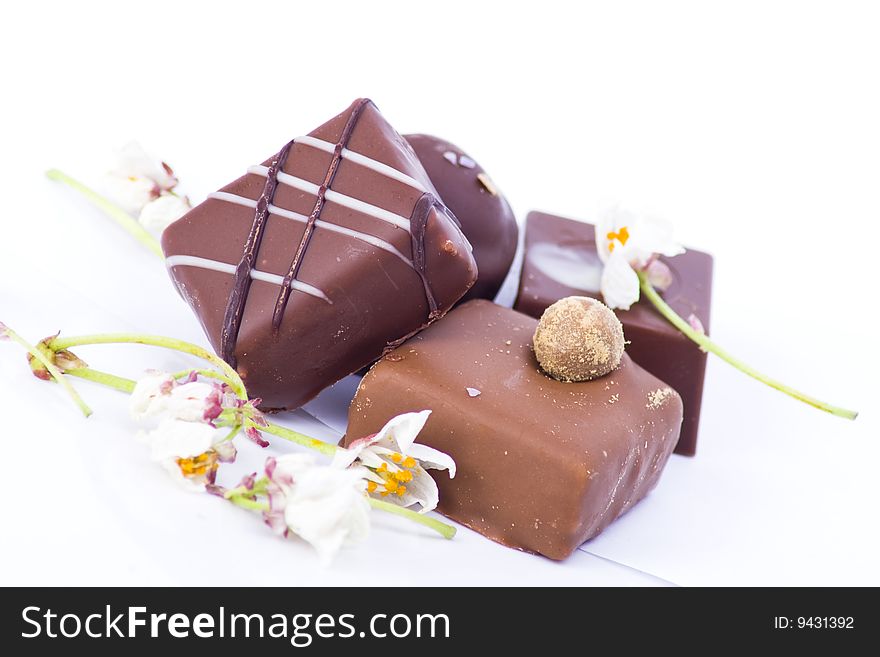 A selection of luxury chocolates with mini decorative flowers. A selection of luxury chocolates with mini decorative flowers