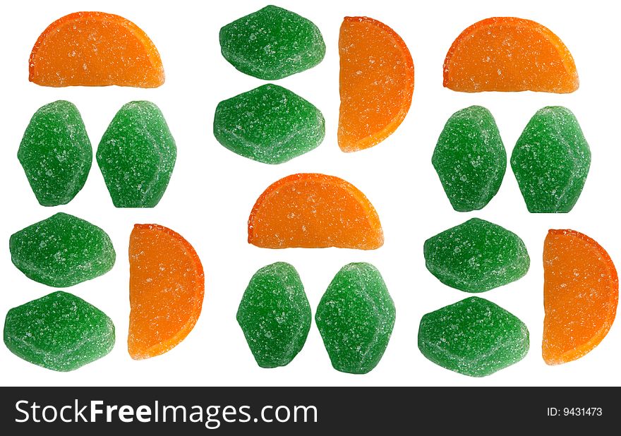 Fruit candy green and in the form of orange segments on a white background