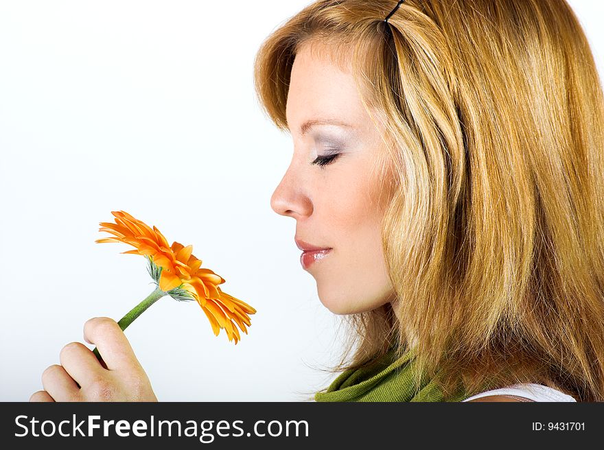 Beauty portrait of a smiling woman with a flower