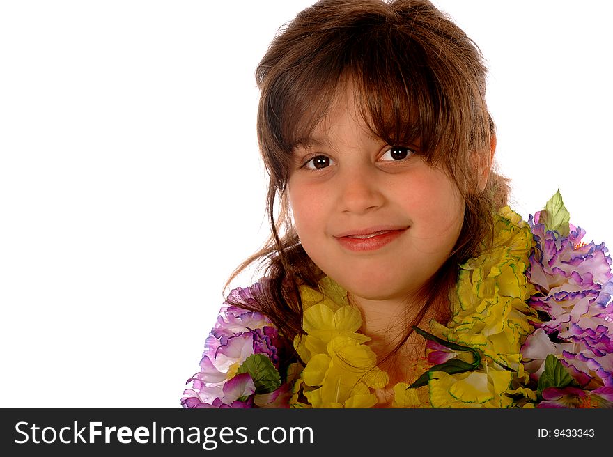 Portrait of a happy elementary girl dressed in multiple Hawaiian lies.  Isolated on white. Portrait of a happy elementary girl dressed in multiple Hawaiian lies.  Isolated on white.