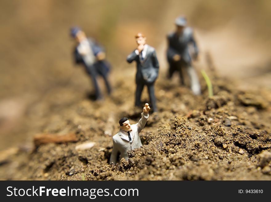 Business figurines placed outside in the dirt. Business figurines placed outside in the dirt