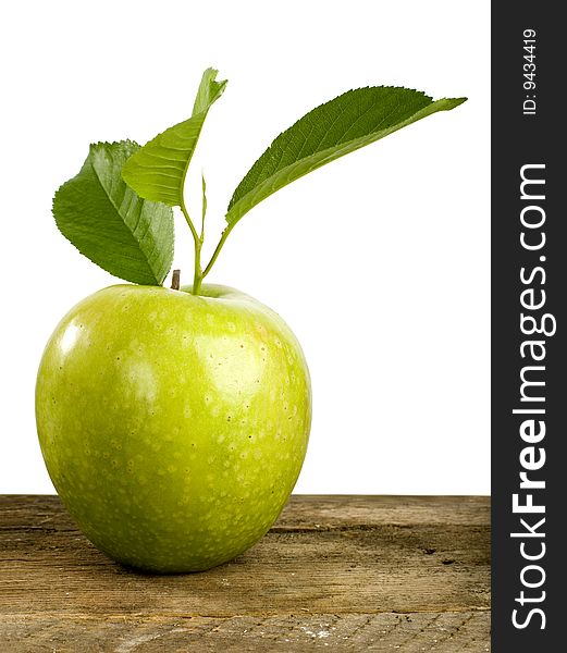 Fresh green apple on a wooden table