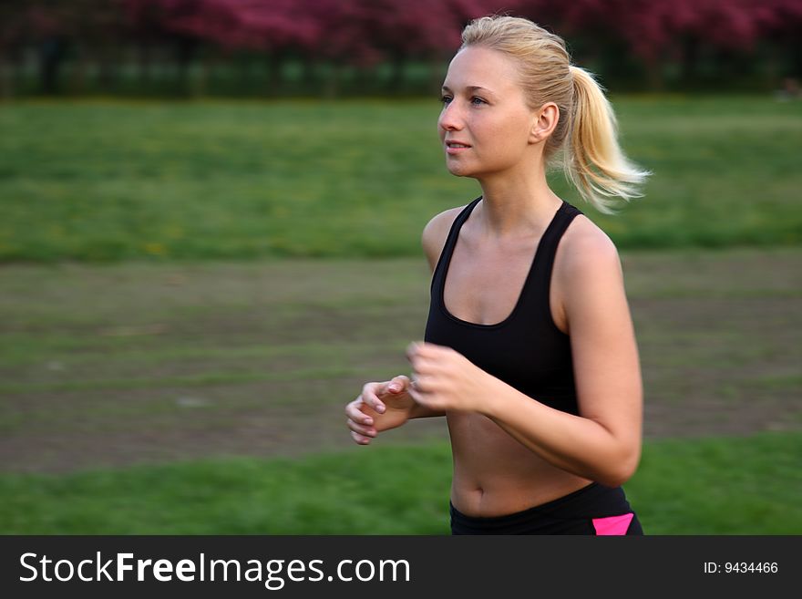 Young fitness woman running outdoor. Young fitness woman running outdoor