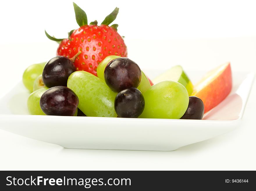 Fruit plate with strawberry, grape, mango and apple slices