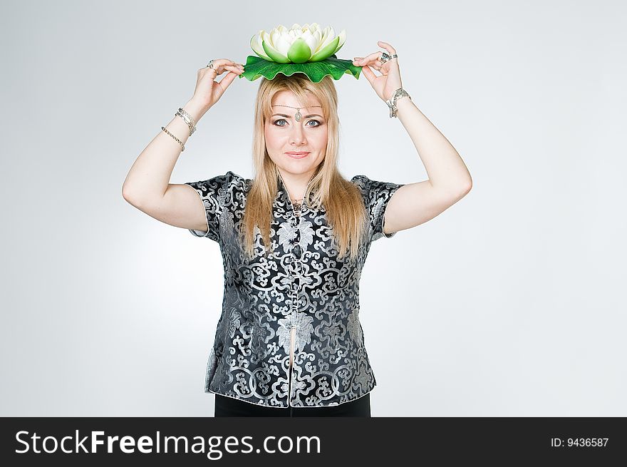 Woman with lotus flower, studio shot