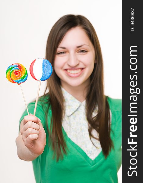 Young smiling girl with lollipops, focus on sweets