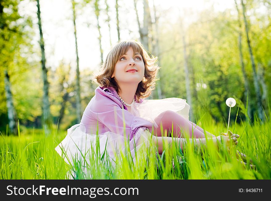 Beautiful girl outdoors with dandelion