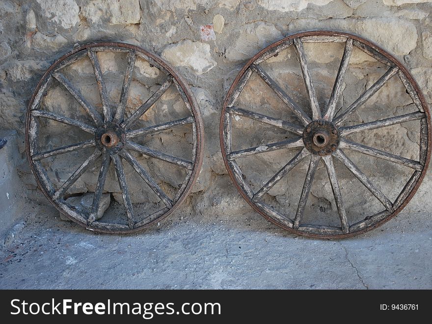Two cart-wheels against the wall in Crimea