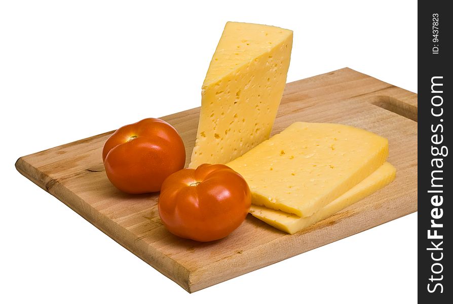 Cheese and tomatoes on wooden board