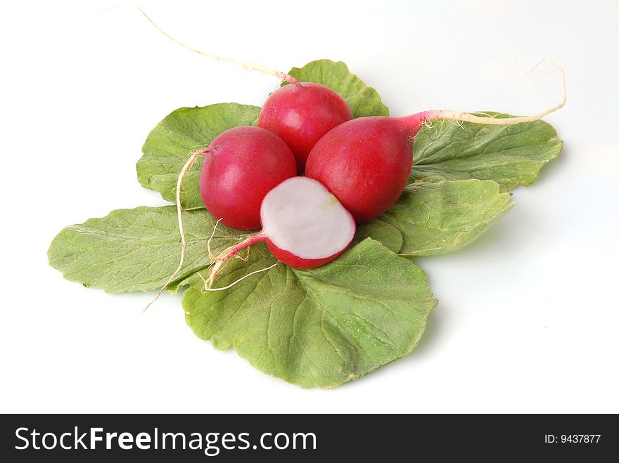 Half and whole a radish on a white background