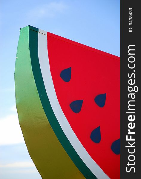Slice of watermelon against blue sky