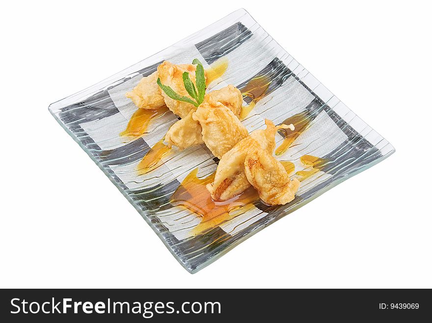Plate with banana in tempura on white. Plate with banana in tempura on white