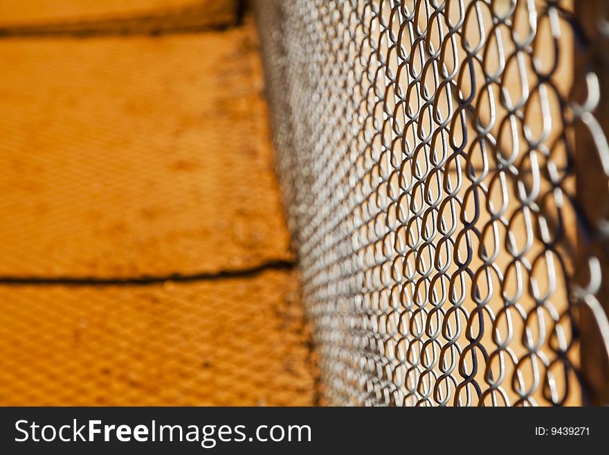 Chain link fence on a baseball field with no players in view