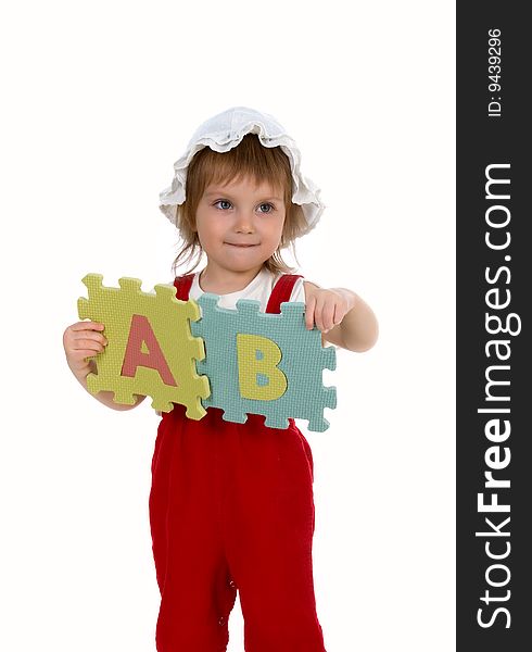 Little girl and letters on white background