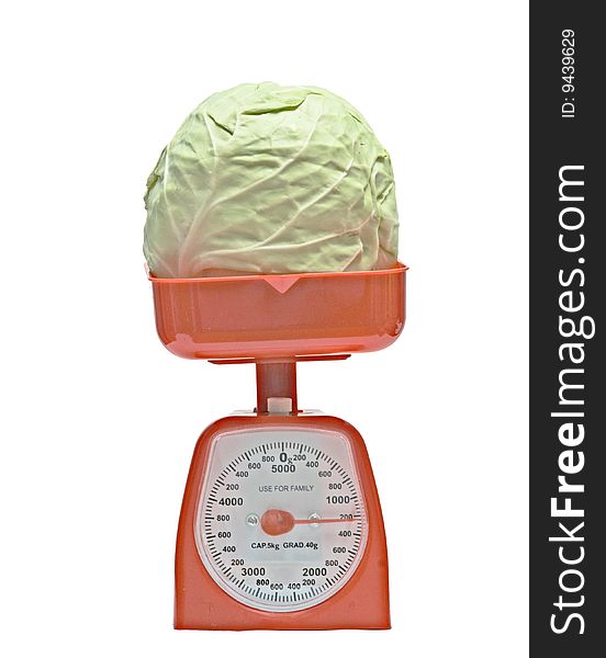 Red kitchen scale weighting cabbage