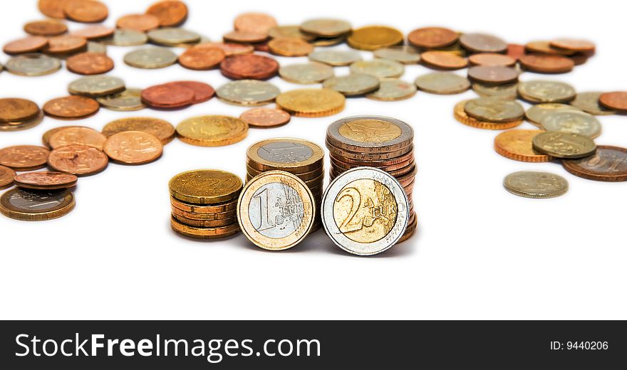 Several piles of coins isolated on white background