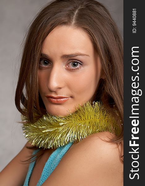 Young model in a blue dress on a grey background