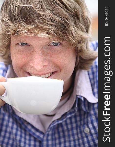 Young blond man drinking coffee. Young blond man drinking coffee