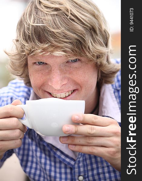 Young blond man drinking coffee. Young blond man drinking coffee