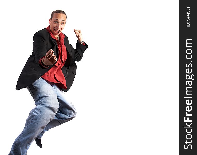 A young businessman with a red shirt, a jacket and blue jeans is jumping in joy. Isolated over white. Slight motion bluriness is intended. A young businessman with a red shirt, a jacket and blue jeans is jumping in joy. Isolated over white. Slight motion bluriness is intended.