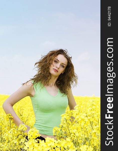 Portrait of a young woman in rape flower field. Portrait of a young woman in rape flower field