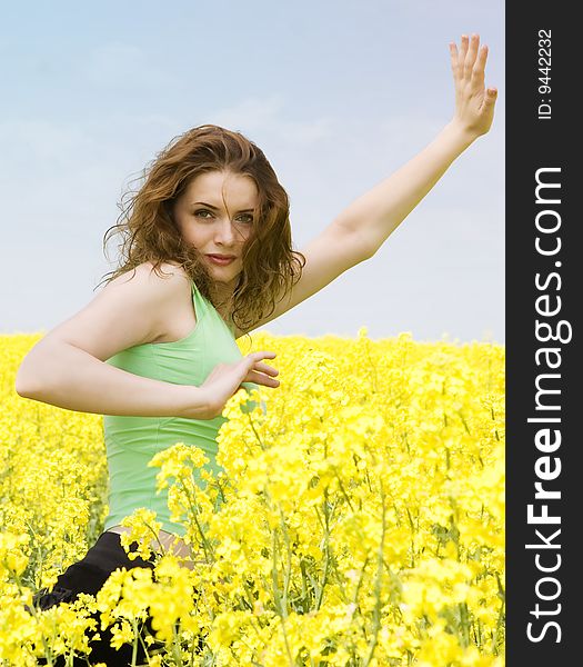 Attractive Girl Doing Yoga In Rape Flower Field