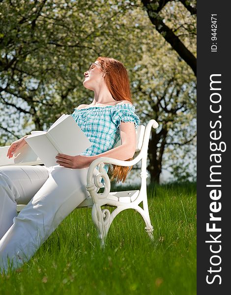 Woman relax under blossom tree in summer