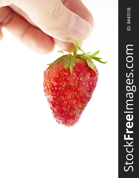 Fresh strawberry in hand on a white background