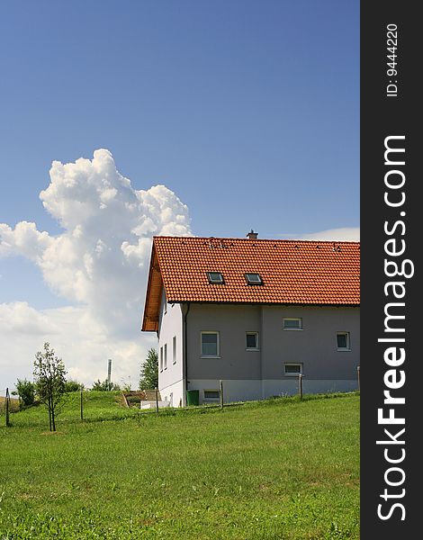 Austrian red roof house green field