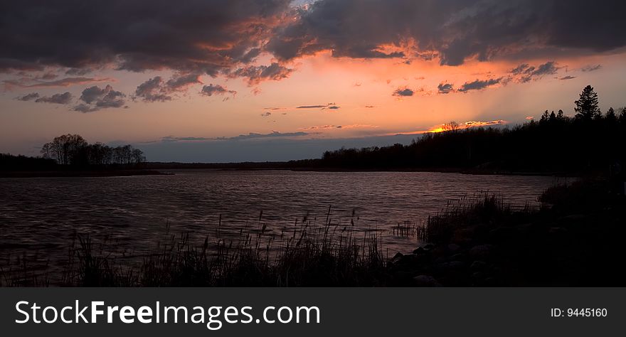 Weather over Wild Race Lake at sunset in Northern Minnesota. Weather over Wild Race Lake at sunset in Northern Minnesota