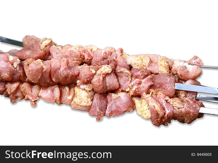 Pieces of raw meat ready to be grilled on the barbecue. Pieces of raw meat ready to be grilled on the barbecue