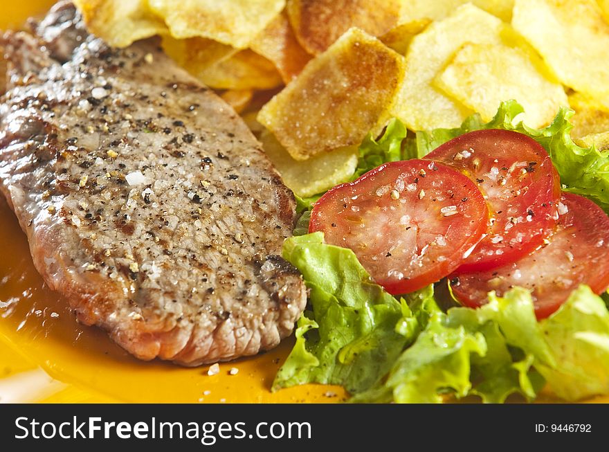 Juicy beef steak with chips and salad. Juicy beef steak with chips and salad