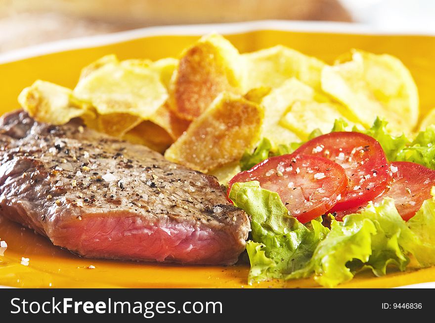 Juicy beef steak with chips and salad. Juicy beef steak with chips and salad