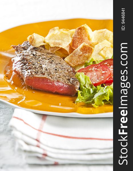 Juicy beef steak with chips and salad. Juicy beef steak with chips and salad