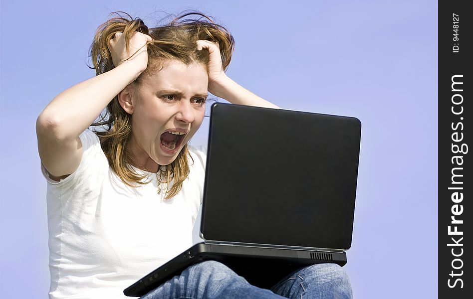 Angry surprised woman working on laptop outdoors. Angry surprised woman working on laptop outdoors