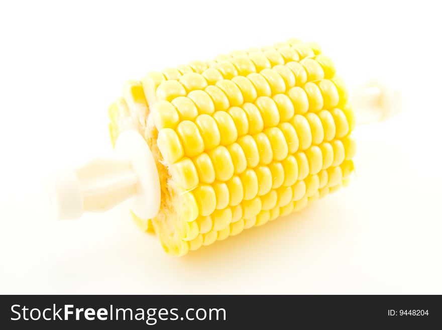 Cut section of a maize ear unwrapped and showing yellow kernels on a white background. Cut section of a maize ear unwrapped and showing yellow kernels on a white background