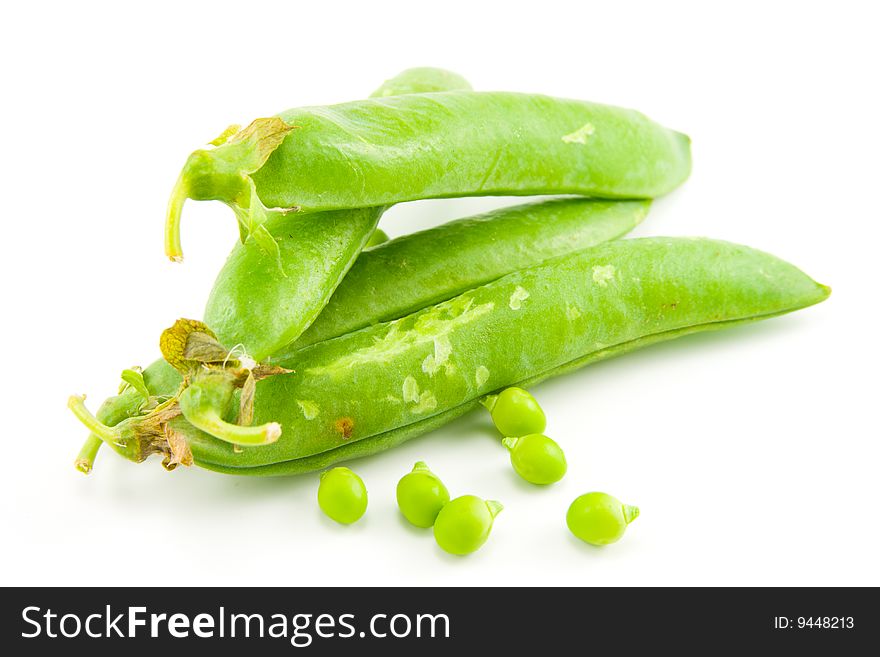 Four whole ripe peapods or english peas containing peas on a white background